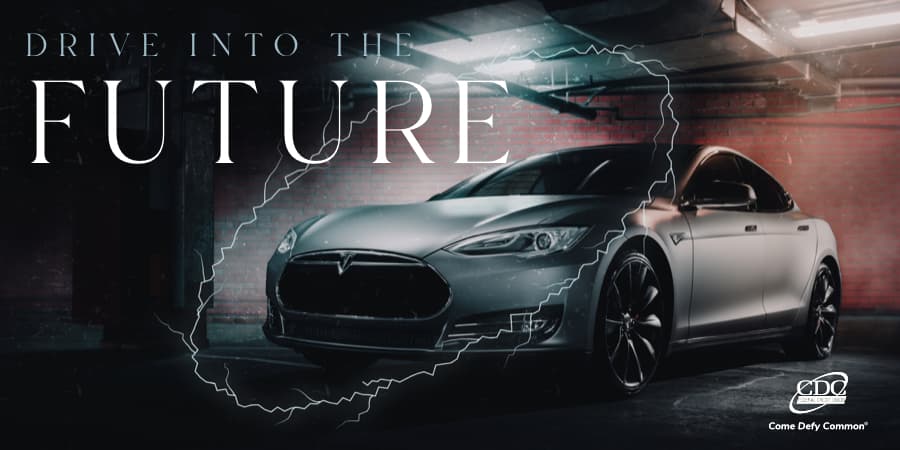 A tesla parked in a low-light garage with a superimposed oval in the shape of electricity. At the top, the words: drive into the future.