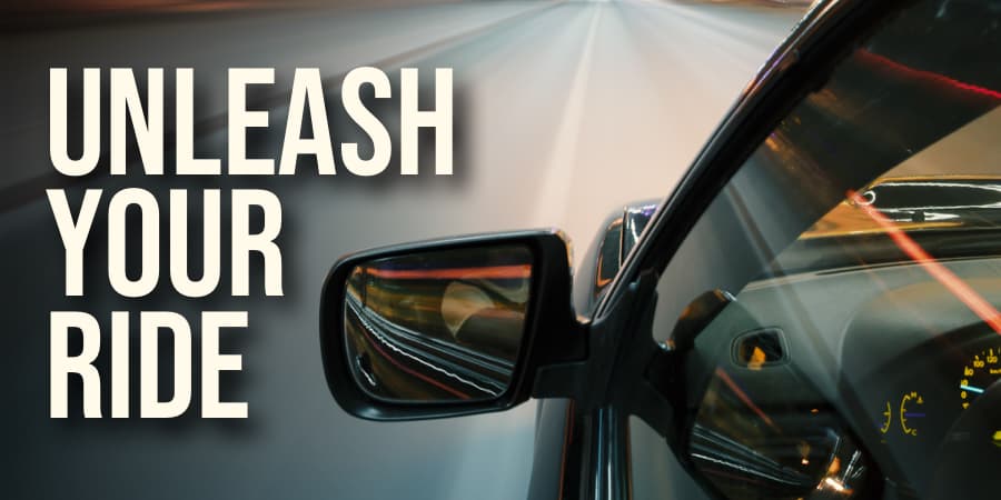 The driver's side view of a car with the focus on the rearview mirror. To the left, the words: unleash your ride.
