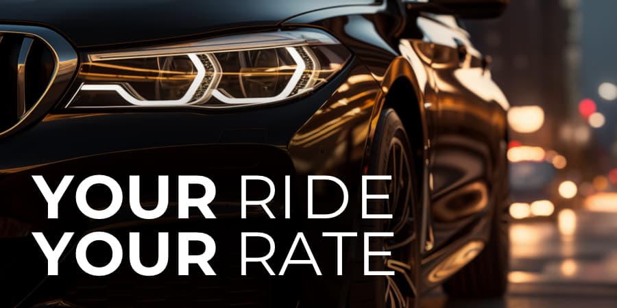 A close up of a black luxury vehicle in an urban setting at night. At the bottom, the words: your ride your rate.