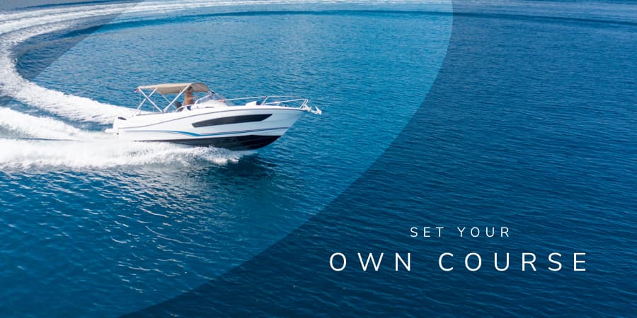 An arial view of an open fisherman boat on the ocean. At the bottom right, the words: set your own course.