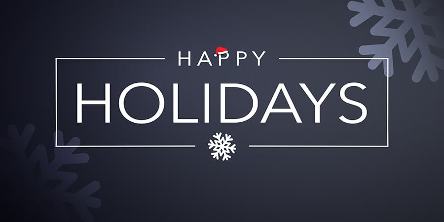 An illustration of snow flakes against a charcoal gray background. At the center, the words: happy holidays.