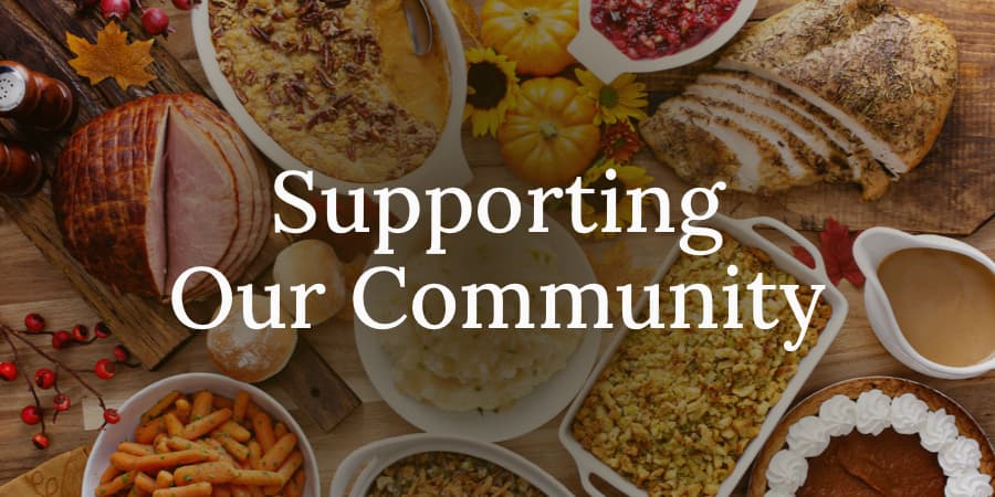 A top view of Thanksgiving platters. Across the center, the words: supporting our community.