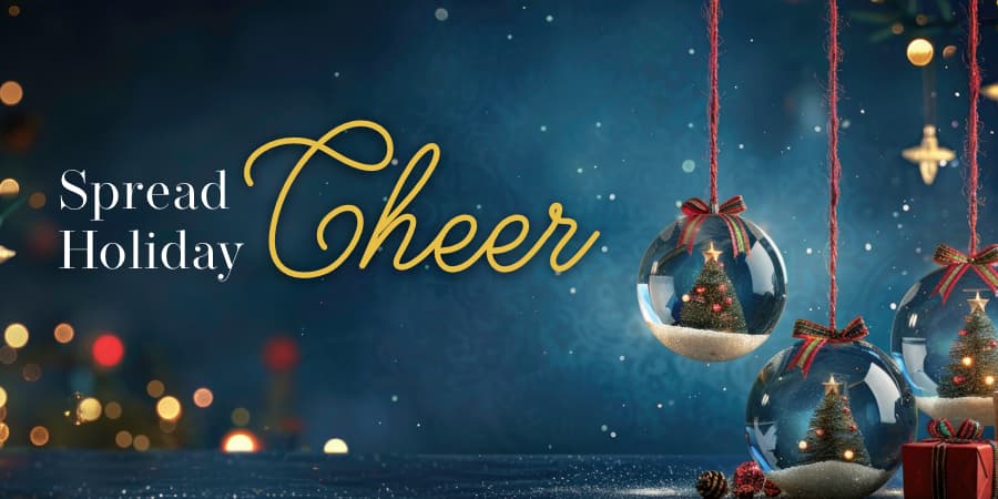 Glass holiday ornaments with Christmas trees inside. To the left, the words: spread holiday cheer.