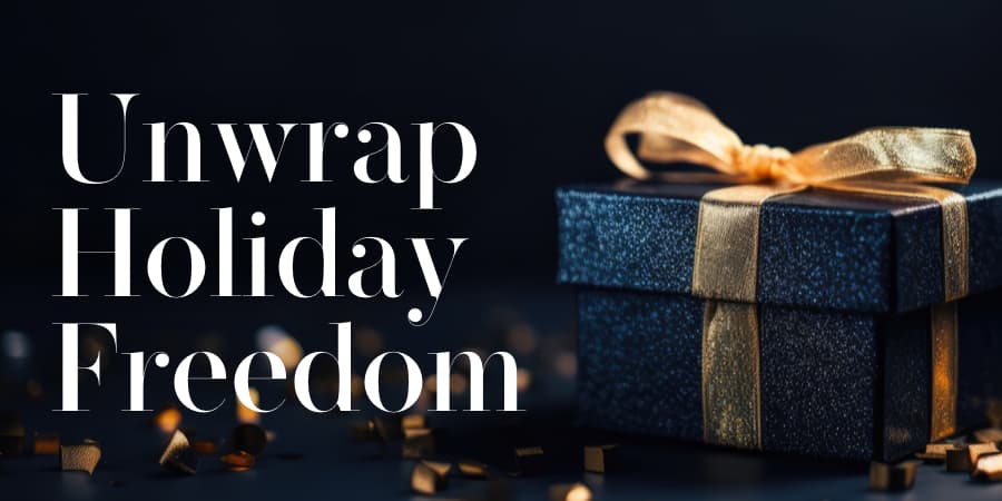 A beautifully wrapped navy box with a gold ribbon surrounded by gold confetti. To the left, the words: unwrap holiday freedom.