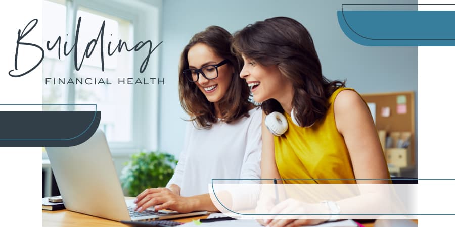 Two young women sitting at a desk looking at an open laptop. To the left, the words: building financial health.