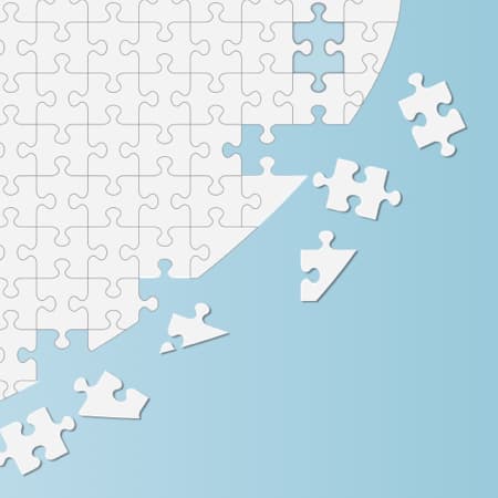 A world map made up of puzzle pieces.