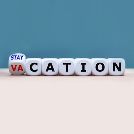 A row of letter blocks spelling out the word: Stay Vacation.