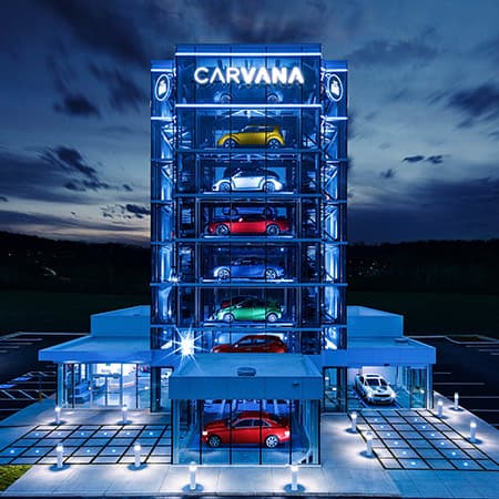 A brightly lit Carvana car delivery tower.