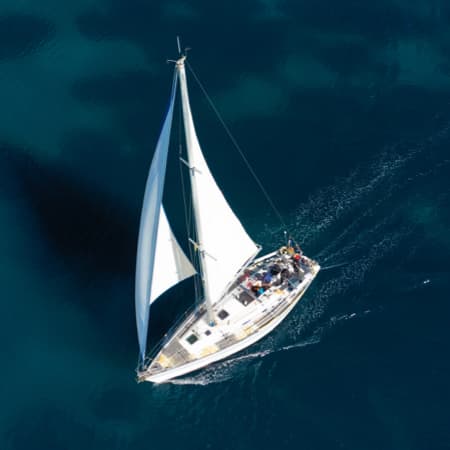 A sailboat sailing on the open, blue ocean.