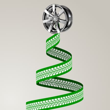 Three green ribbons with white tire mark patterns forming a christmas tree. At the top of each tree, a high-polished wheel.