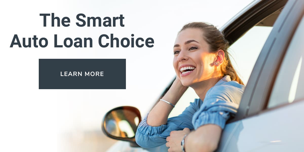 A woman leaning out of her car window with a big smile. To the left, the words: the smart auto loan choice.
