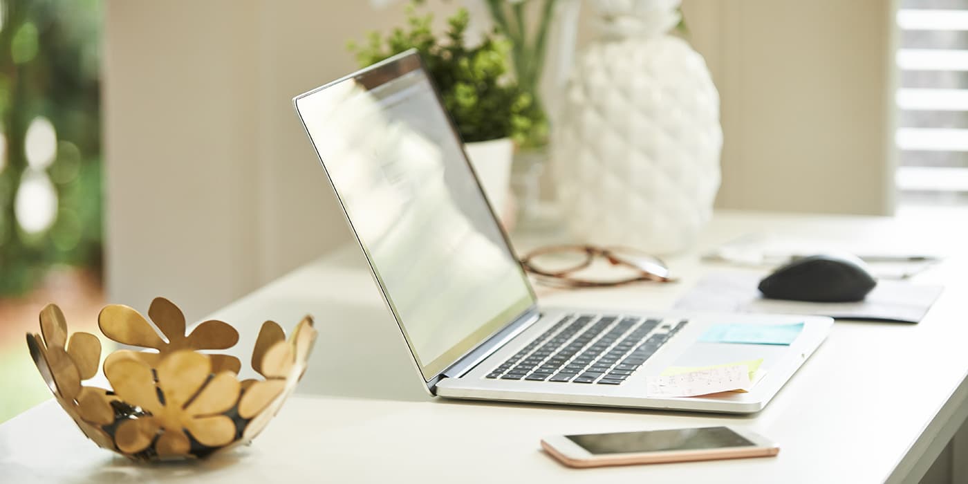 An open laptop resting on a desk.