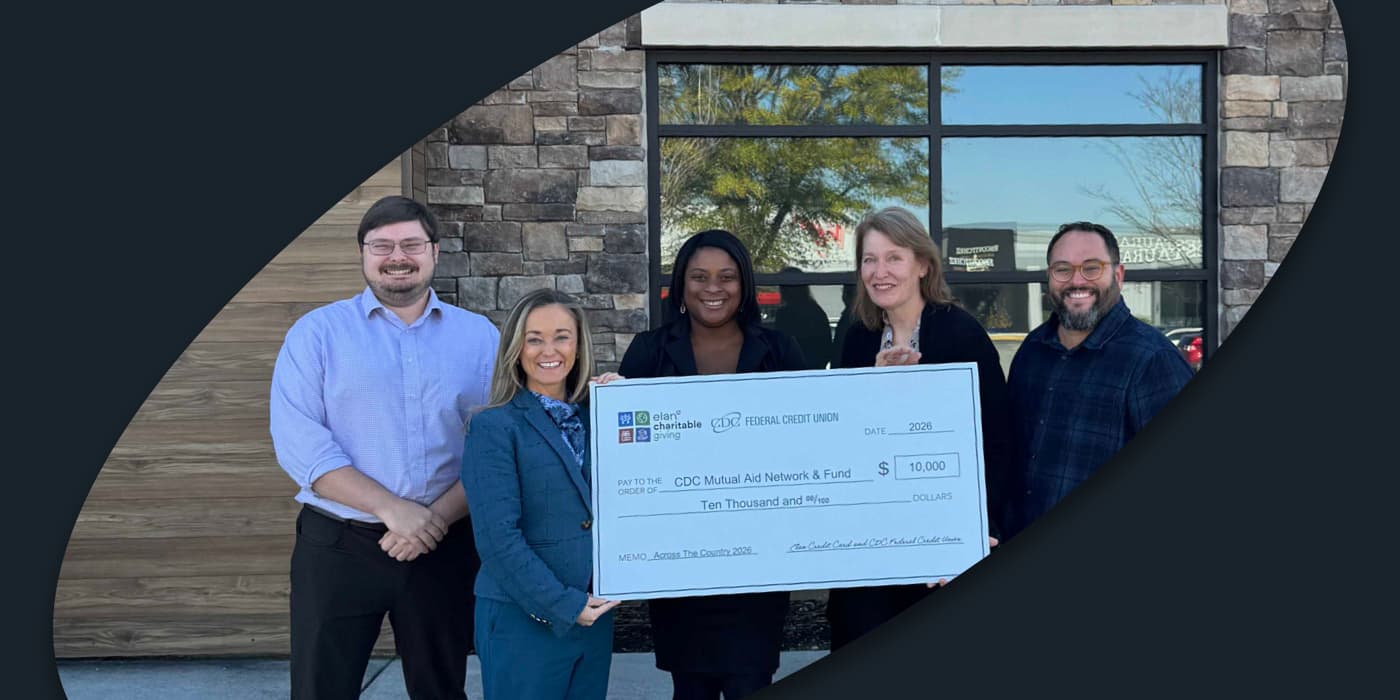 CDC FCU employees holding a large check.