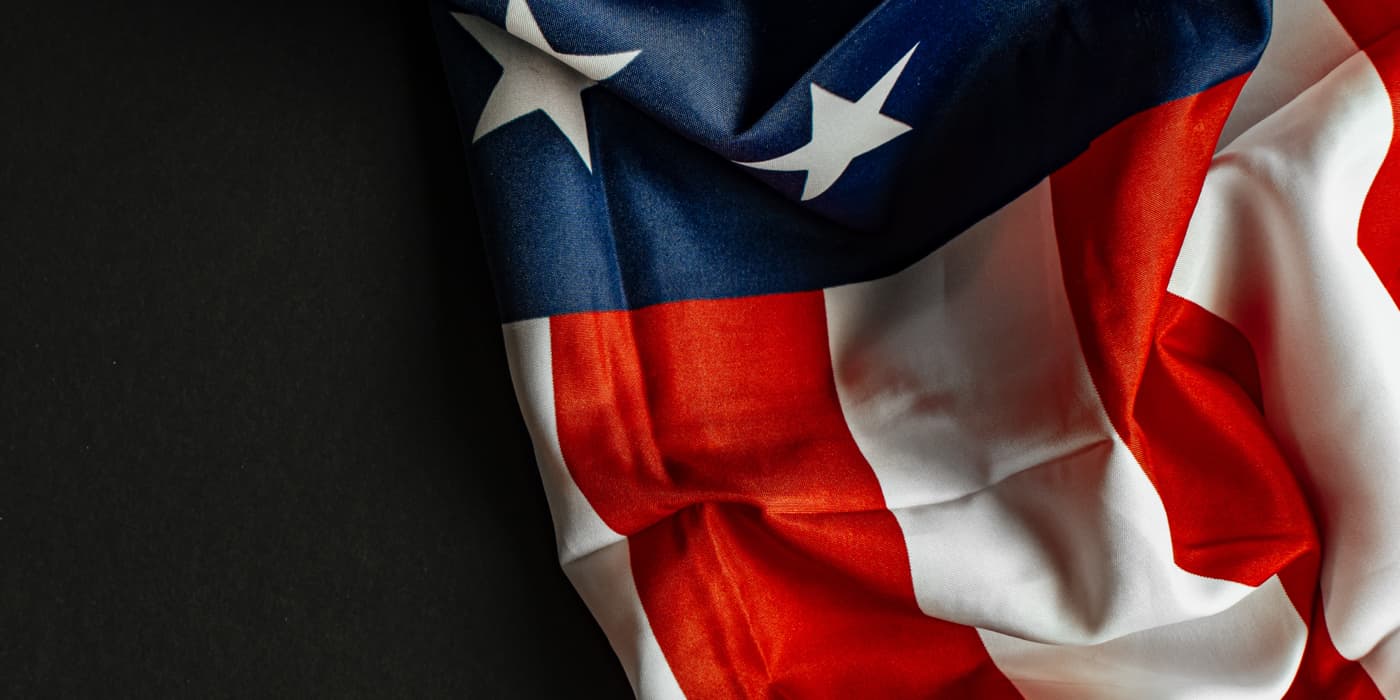 An American flag resting on a dark surface.