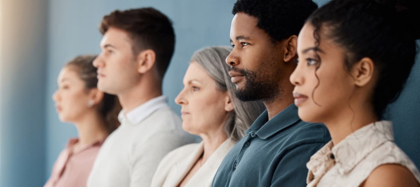 A side profile view of a diverse group of people.