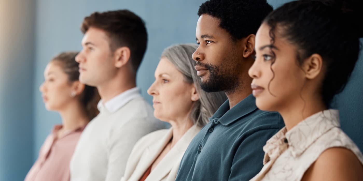 A side profile view of a diverse group of people.